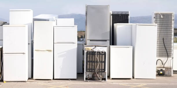 istock Old fridge freezer refrigerator refrigerant gas at refuse dump skip recycle stacked pile plant help environment reduce pollution white silver 1200384623