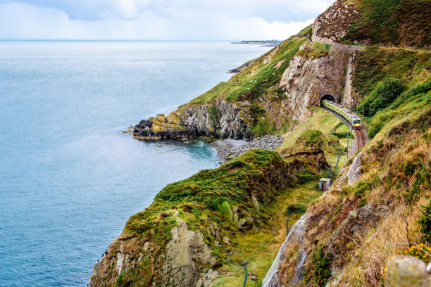 Train exiting a tunnel. View from Cliff Walk Bray to Greystones, Ireland stock photo