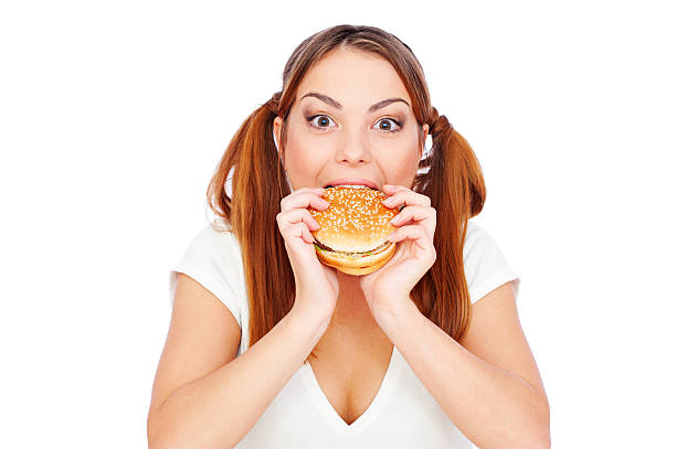 istock pretty woman eating burger with gusto 120038475