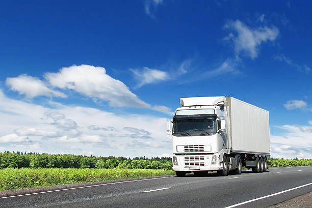 white truck on country highway stock photo