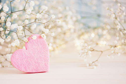 Pink heart, gypsophila flowers and bokeh lights - love concept background