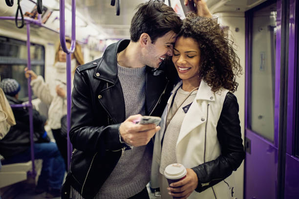 istock Happy couple is texting in the subway 1200387345