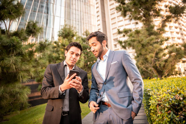istock Businessmen looking at the phone 1200387570