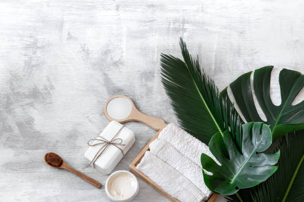 istock Spa. Body care items on a white background with tropical leaves. Summer accessories. Space for text. 1200387572