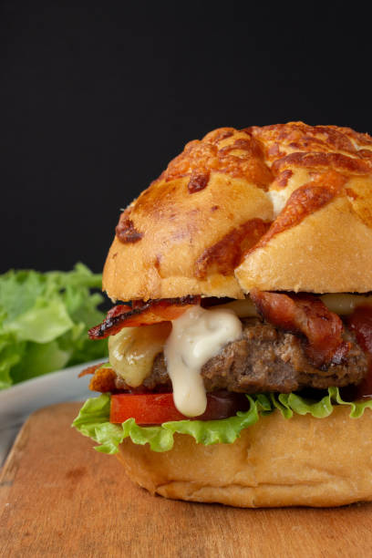 istock Bacon Cheese Burger with tomato, lettuce and a drop of mayonnaise. 1200388784