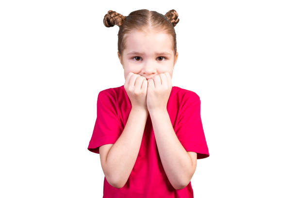istock The girl bites her nails and got scared. Isolated on a white background. 1200390847
