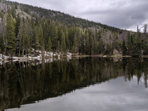 istock Wooded Lake in the Mountains with Reflection 1200390973