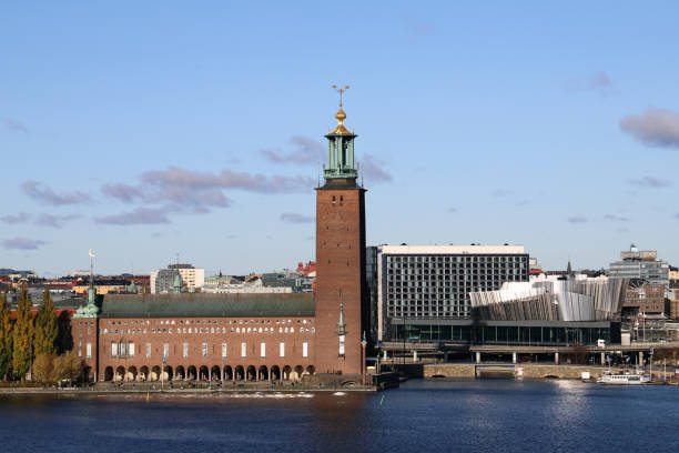 istock Gilded Crown on Skeppsholmsbron by dusk with dramatic dark collored sky at the river with a view at Gamla Stan in Stockholm Sweden. Focus is on the background, crown not in focus 1200394546