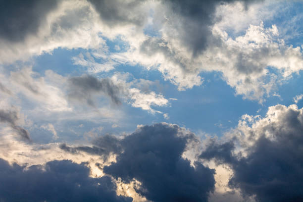 istock the sun shining through the clouds against the blue sky, light clouds 1200396330