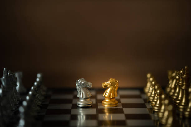 istock Gold and white knights chess in battle. 1200405524