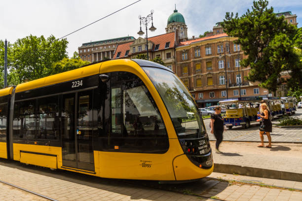 Budapest, Modern Budapest Tram  with dome of Buda Castle in the background–  on July  4 2019 in Hungary.