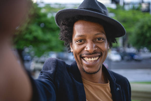 istock Fashionable hipster smiling while taking a selfie 1200409225