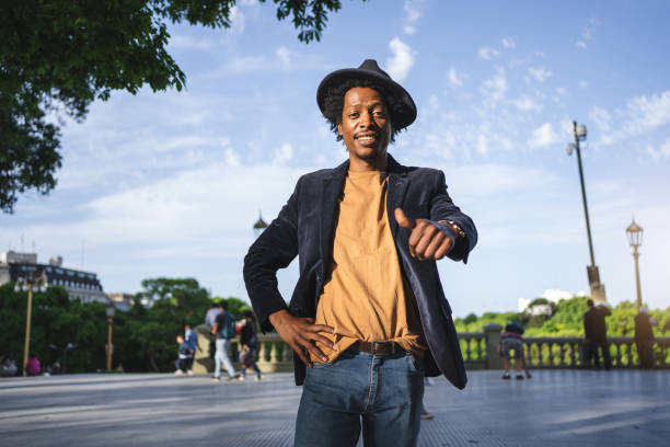 istock Carefree hipster holding a thumbs up while smiling 1200409287