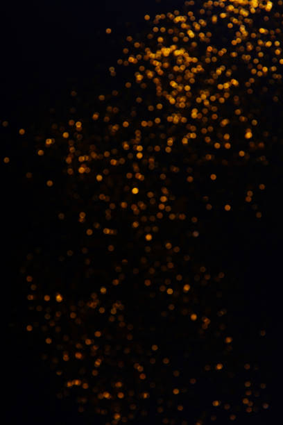 istock Beautiful blurred golden background on black 1200416983