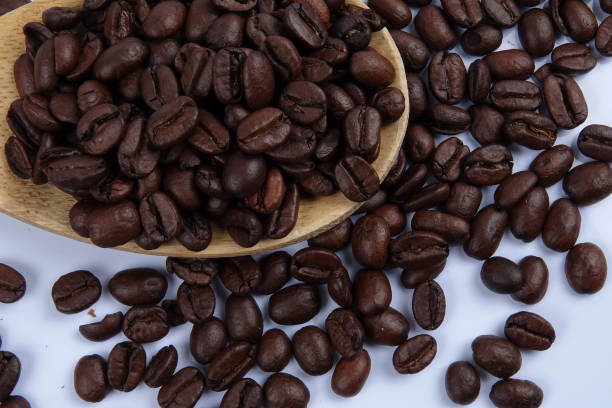 istock roasted coffee beans isolated on white background close up. 1200419238