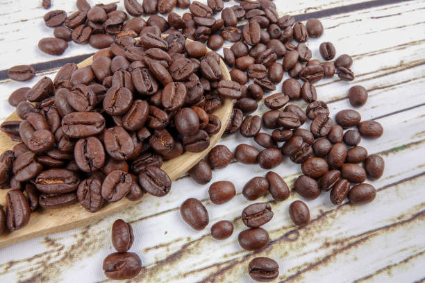 istock coffee beans and wooden spoon on old rusty background 1200419268