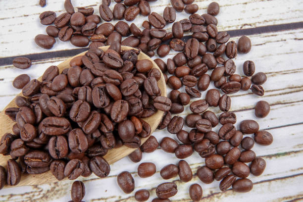 istock coffee beans and wooden spoon on old rusty background 1200419270