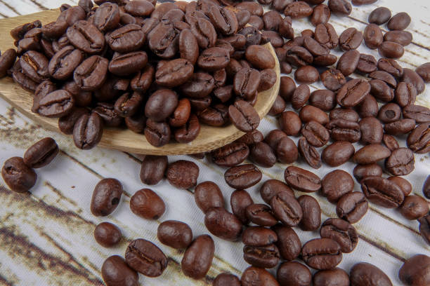 istock coffee beans and wooden spoon on old rusty background 1200419271