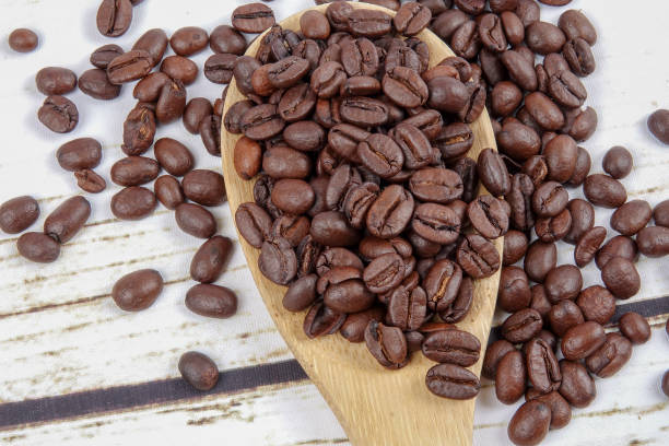 istock coffee beans and wooden spoon on old rusty background 1200419281