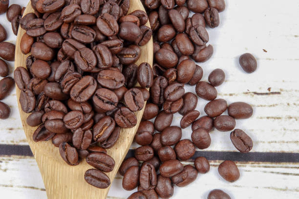 istock coffee beans and wooden spoon on old rusty background 1200419291