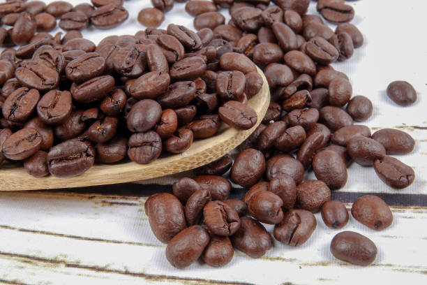 istock coffee beans and wooden spoon on old rusty background 1200419293