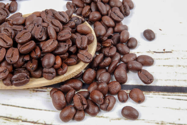istock coffee beans and wooden spoon on old rusty background 1200419294