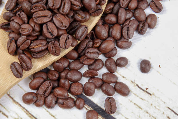 istock coffee beans and wooden spoon on old rusty background 1200419301