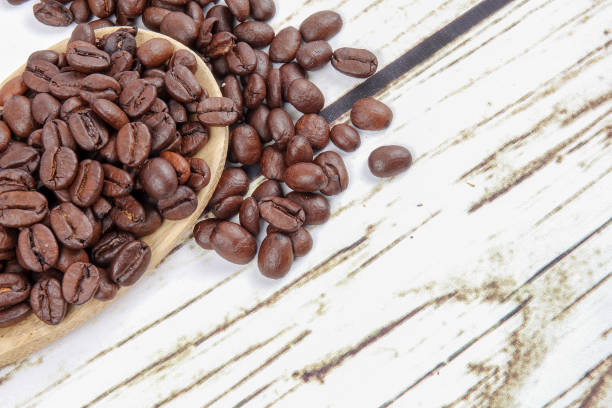 istock coffee beans and wooden spoon on old rusty background 1200419306
