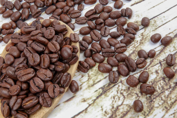 istock coffee beans and wooden spoon on old rusty background 1200419311