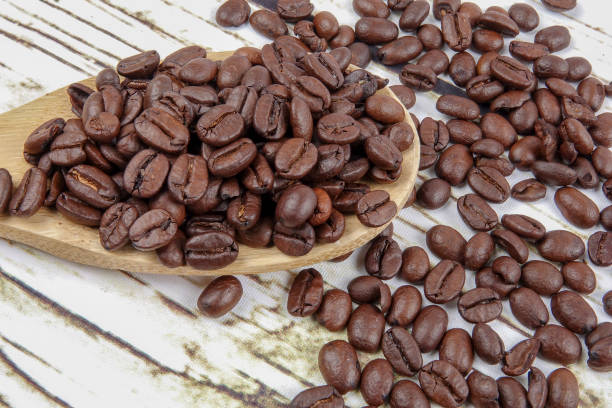 istock coffee beans and wooden spoon on old rusty background 1200419316