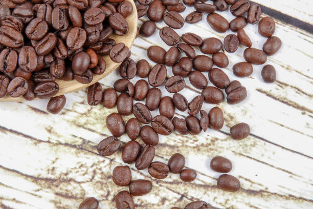 istock coffee beans and wooden spoon on old rusty background 1200419319