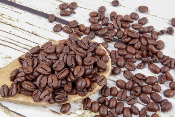istock coffee beans and wooden spoon on old rusty background 1200419320