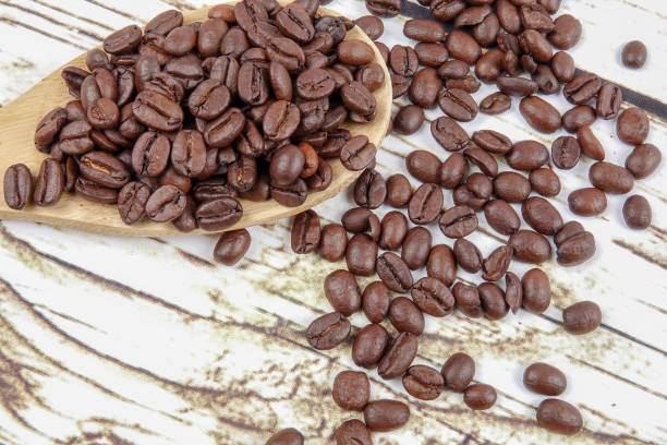 istock coffee beans and wooden spoon on old rusty background 1200419324