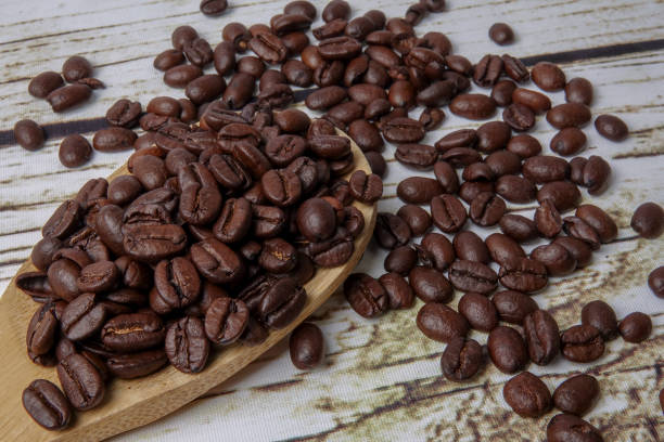 istock coffee beans and wooden spoon on old rusty background 1200419327