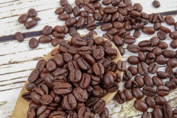 istock coffee beans and wooden spoon on old rusty background 1200419329