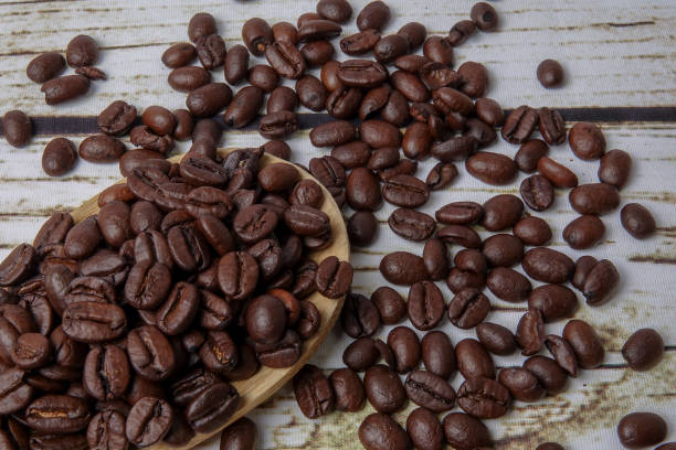 istock coffee beans and wooden spoon on old rusty background 1200419332