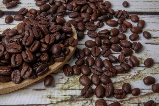 istock coffee beans and wooden spoon on old rusty background 1200419333