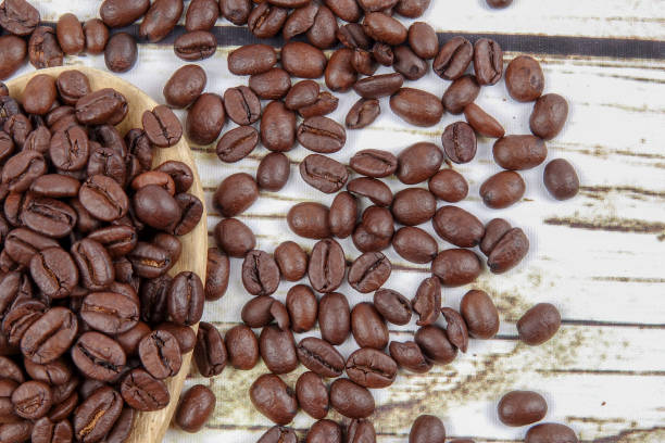 istock coffee beans and wooden spoon on old rusty background 1200419337