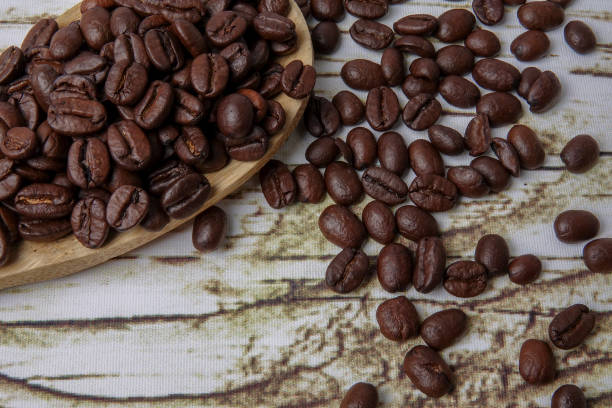 istock coffee beans and wooden spoon on old rusty background 1200419362