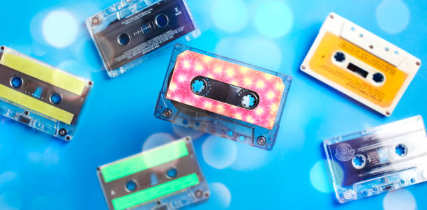 istock Retro cassette tape collection on blue background with bokeh, top view. 1200426627