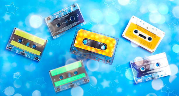 istock Retro cassette tape collection on blue background with bokeh, top view. 1200426646