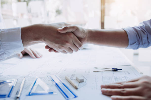 istock Two engineering man with construction worker greeting a foreman at renovating apartment. 1200428574