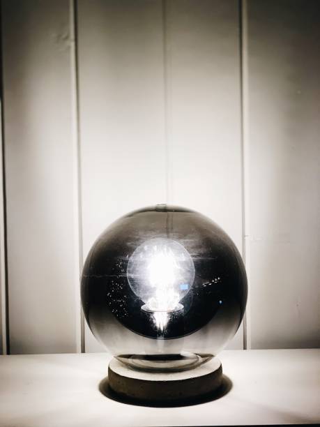 istock Beautiful Orb Light On White Table Against White Wood 1200429407