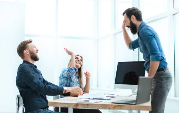 istock satisfied employees giving each other a high five 1200430032