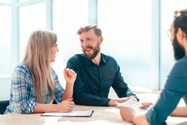 istock young man answering questions from interviewers in the office. 1200431419