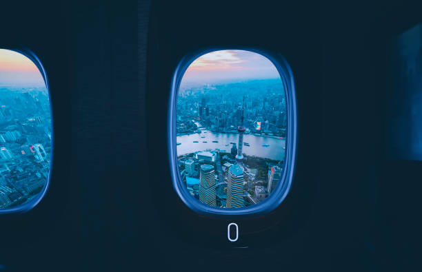 Shanghai city seen through an aircraft window at a sunset in China.