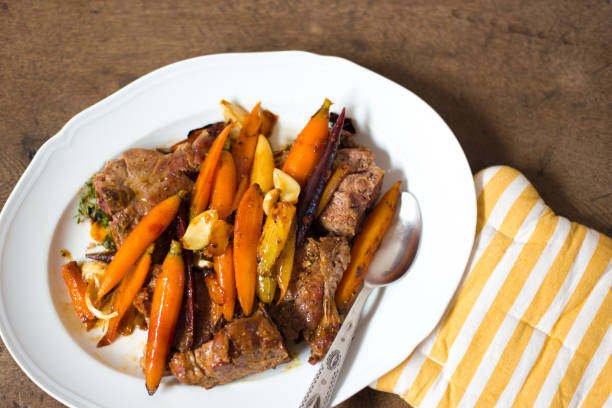 istock Lamb Chops and Carrots on Platter, Overhead Close-Up 1200434183