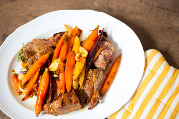 istock Lamb Chops and Carrots on Platter, Overhead Close-Up 1200434208