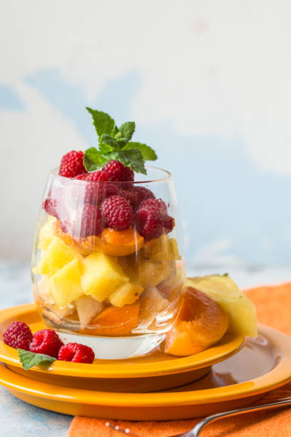 istock Fresh healthy fruit salad. Selective focus. Natural eating. Fruit salad on white background - diet, healthy breakfast. Healthy food dinner table. Gourmet food. Copy space. Tropical fruit. 1200439748