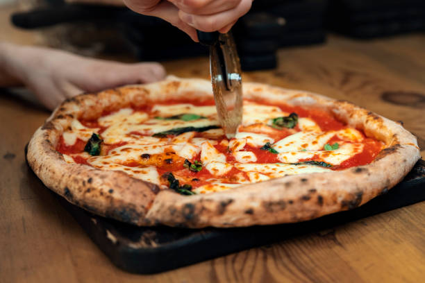 istock Cook cut pizza with a round knife 1200441001